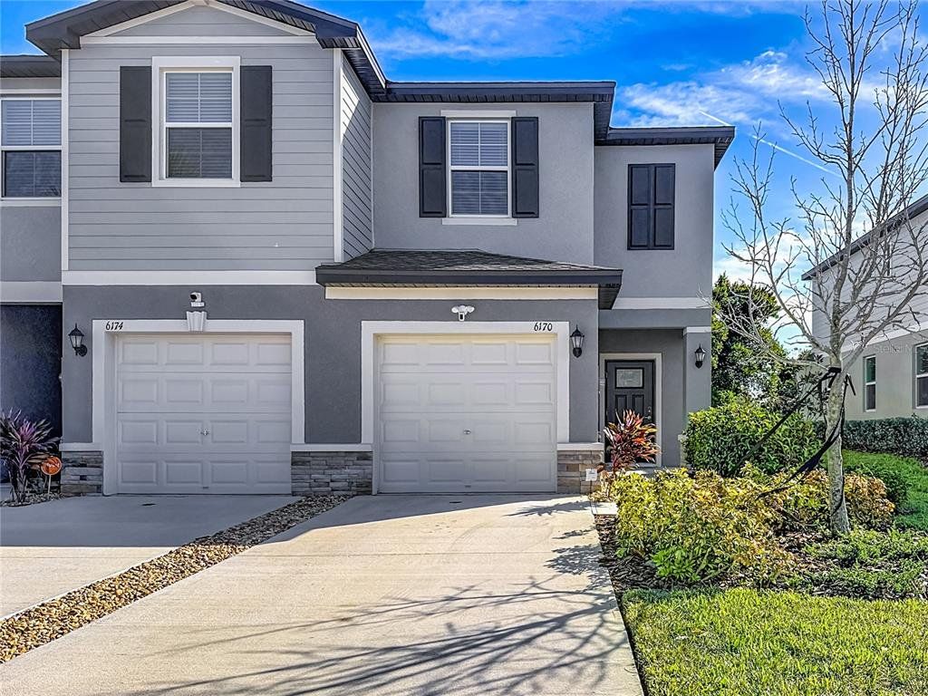 Front exterior of a new home in , Land O' Lakes, FL, highlighting curb appeal (Image 1). Front exterior of a new home in , Land O' Lakes, FL, highlighting curb appeal (Image 1).