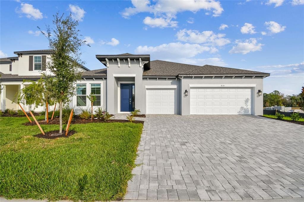 Front exterior of a new home in Creeks Edge at Twin Rivers, Parrish, FL, highlighting curb appeal (Image 1). Front exterior of a new home in Creeks Edge at Twin Rivers, Parrish, FL, highlighting curb appeal (Image 1).