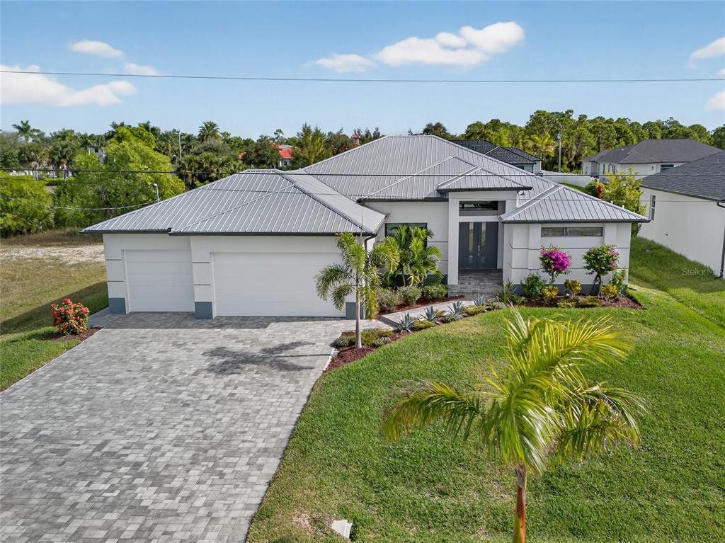 Front exterior of a new home in , Cape Coral, FL, highlighting curb appeal (Image 1). Front exterior of a new home in , Cape Coral, FL, highlighting curb appeal (Image 1).