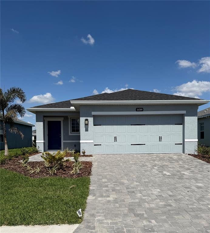 Front exterior of a new home in West Port Single Family Homes, Port Charlotte, FL, highlighting curb appeal (Image 1). Front exterior of a new home in West Port Single Family Homes, Port Charlotte, FL, highlighting curb appeal (Image 1).