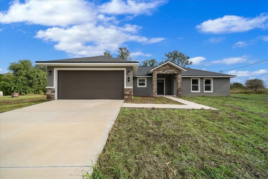 Front exterior of a new home in , Ocklawaha, FL, highlighting curb appeal (Image 1). Front exterior of a new home in , Ocklawaha, FL, highlighting curb appeal (Image 1).
