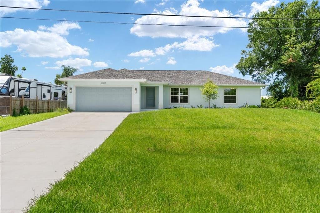 Front exterior of a new home in , Englewood, FL, highlighting curb appeal (Image 1). Front exterior of a new home in , Englewood, FL, highlighting curb appeal (Image 1).