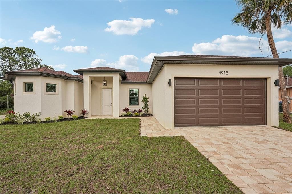 Front exterior of a new home in , North Port, FL, highlighting curb appeal (Image 1). Front exterior of a new home in , North Port, FL, highlighting curb appeal (Image 1).