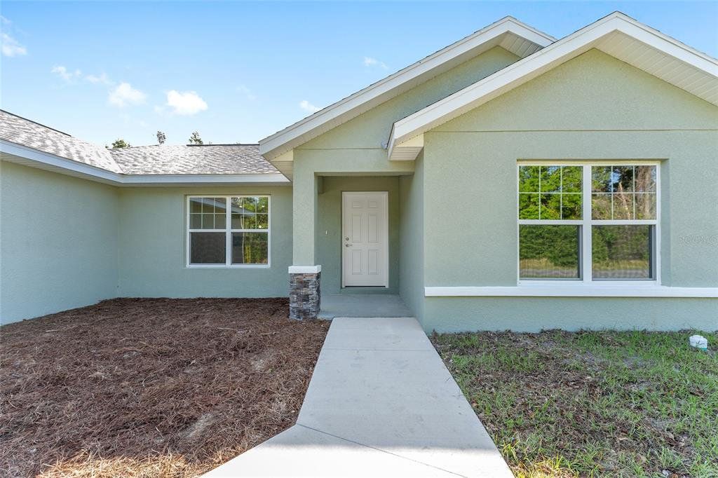 Front exterior of a new home in , Dunnellon, FL, highlighting curb appeal (Image 1). Front exterior of a new home in , Dunnellon, FL, highlighting curb appeal (Image 1).