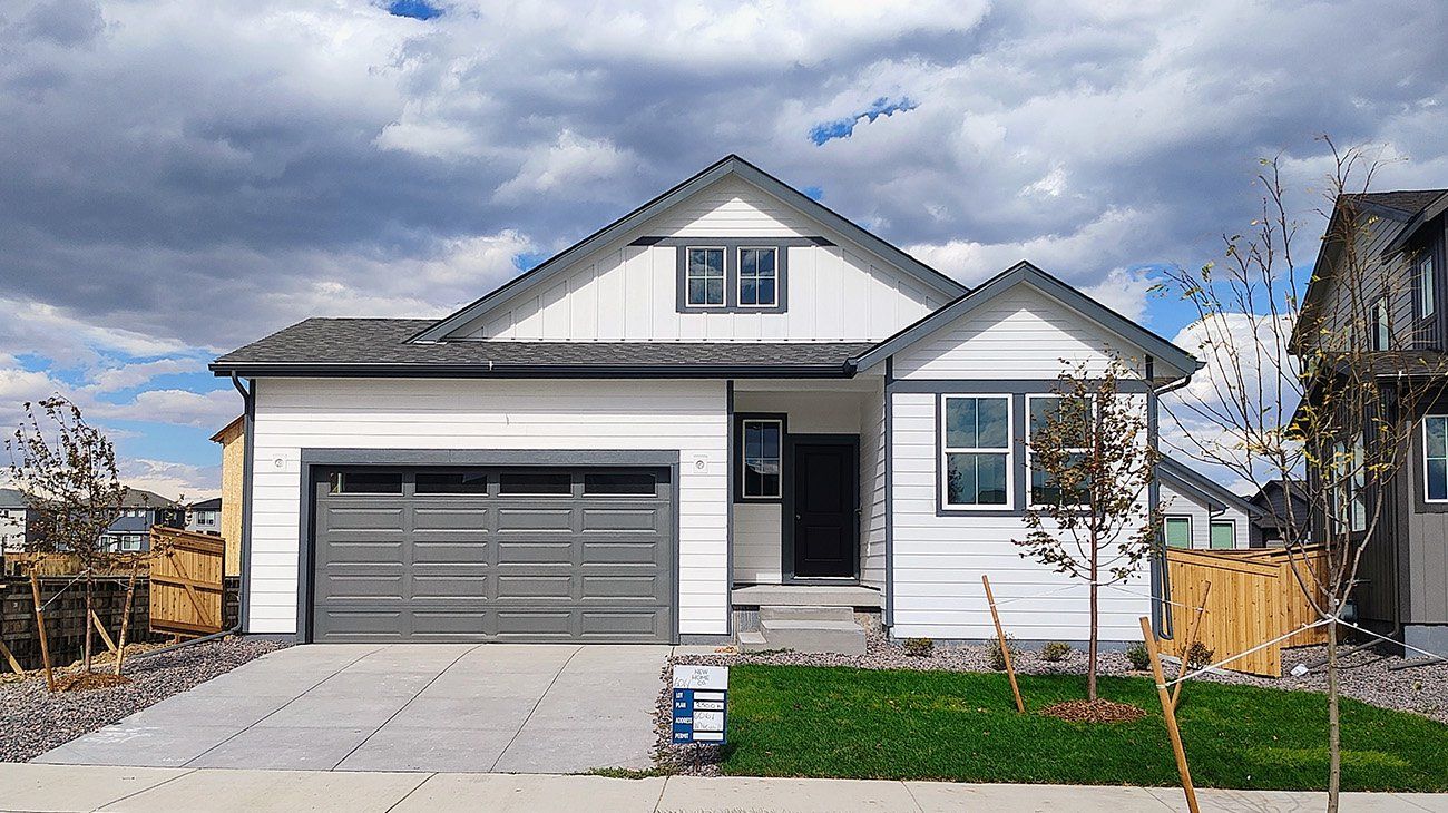 Front exterior of a new home in The Cottages Collection at Ridgeline Vista, Brighton, CO, highlighting curb appeal (Image 1).