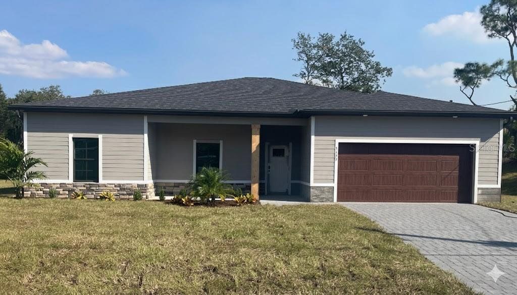 Front exterior of a new home in , North Port, FL, highlighting curb appeal (Image 1). Front exterior of a new home in , North Port, FL, highlighting curb appeal (Image 1).