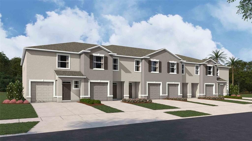 Front exterior of a new home in Towns at Woodsdale, Wesley Chapel, FL, highlighting curb appeal (Image 1).