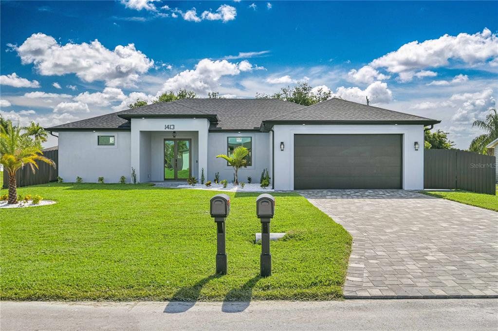 Front exterior of a new home in , Cape Coral, FL, highlighting curb appeal (Image 1). Front exterior of a new home in , Cape Coral, FL, highlighting curb appeal (Image 1).
