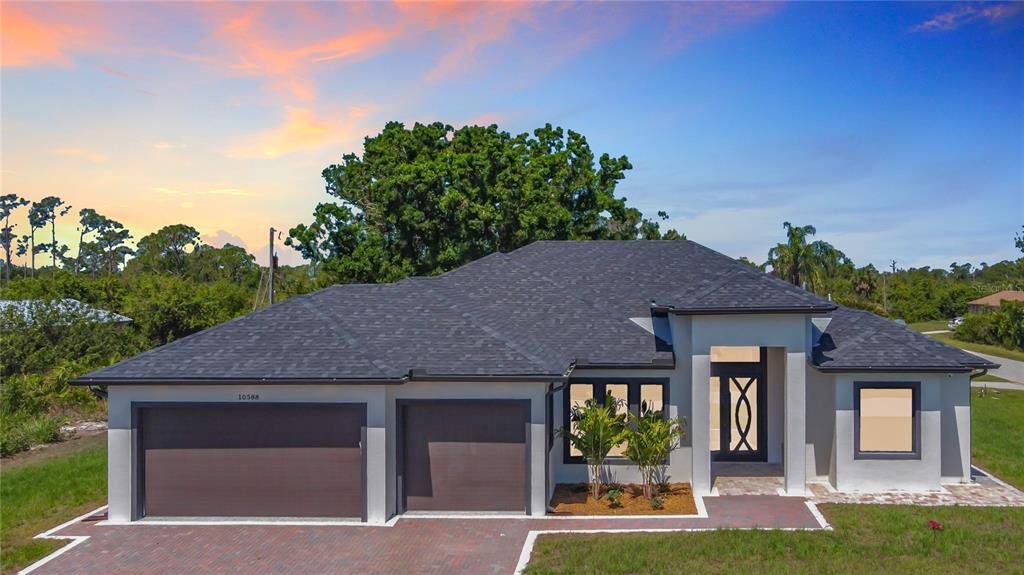 Front exterior of a new home in , Englewood, FL, highlighting curb appeal (Image 1). Front exterior of a new home in , Englewood, FL, highlighting curb appeal (Image 1).