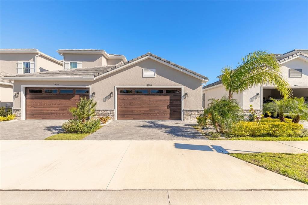Front exterior of a new home in Isles at Venetian Bay/TH, New Smyrna Beach, FL, highlighting curb appeal (Image 1). Front exterior of a new home in Isles at Venetian Bay/TH, New Smyrna Beach, FL, highlighting curb appeal (Image 1).