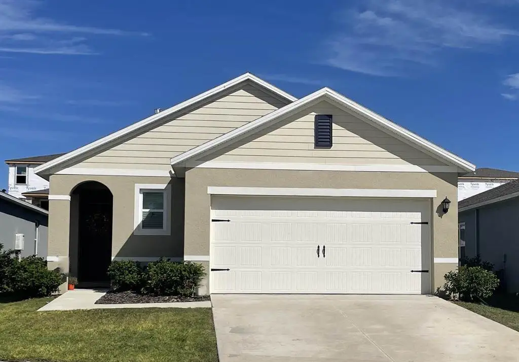Front exterior of a new home in Avalon Park Tavares, Tavares, FL, highlighting curb appeal (Image 1). Front exterior of a new home in Avalon Park Tavares, Tavares, FL, highlighting curb appeal (Image 1).