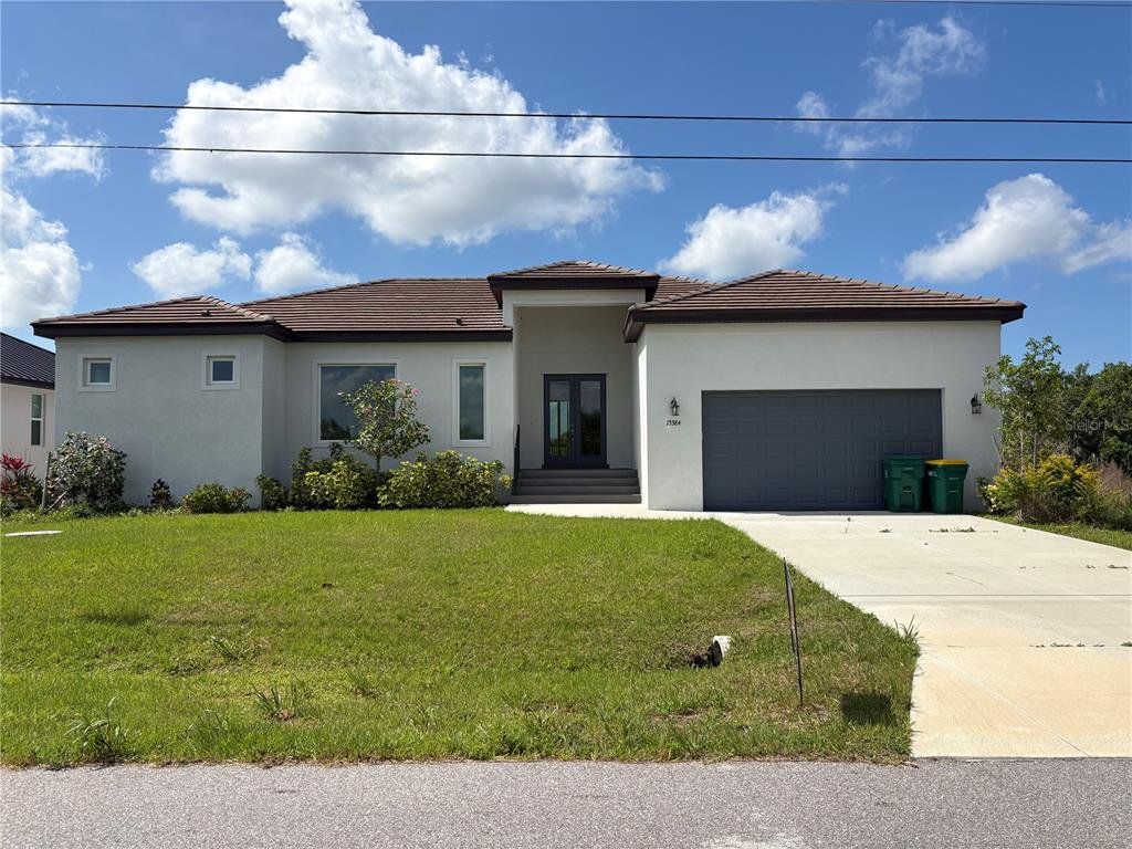 Front exterior of a new home in , Port Charlotte, FL, highlighting curb appeal (Image 1). Front exterior of a new home in , Port Charlotte, FL, highlighting curb appeal (Image 1).
