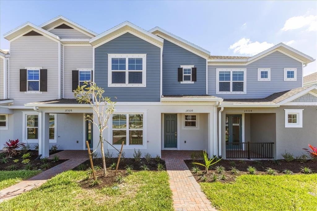 Front exterior of a new home in , Apopka, FL, highlighting curb appeal (Image 1).
