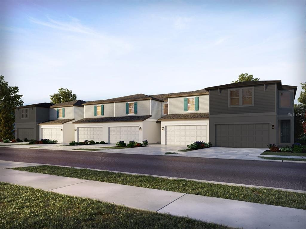 Front exterior of a new home in The Meadow at Crossprairie Townes, St. Cloud, FL, highlighting curb appeal (Image 1). Front exterior of a new home in The Meadow at Crossprairie Townes, St. Cloud, FL, highlighting curb appeal (Image 1).