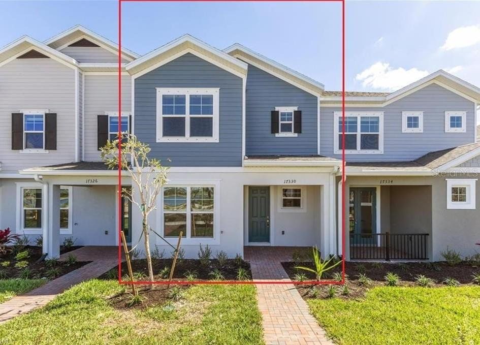 Front exterior of a new home in Townwalk at Babcock Ranch, Punta Gorda, FL, highlighting curb appeal (Image 1).