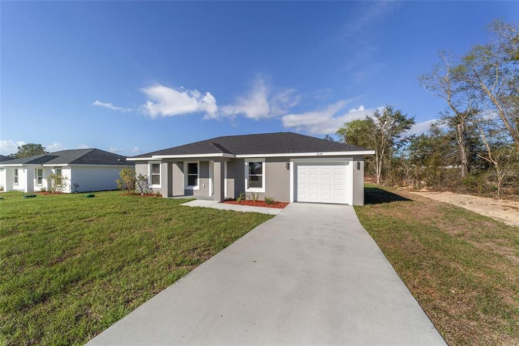 Front exterior of a new home in , Dunnellon, FL, highlighting curb appeal (Image 1). Front exterior of a new home in , Dunnellon, FL, highlighting curb appeal (Image 1).