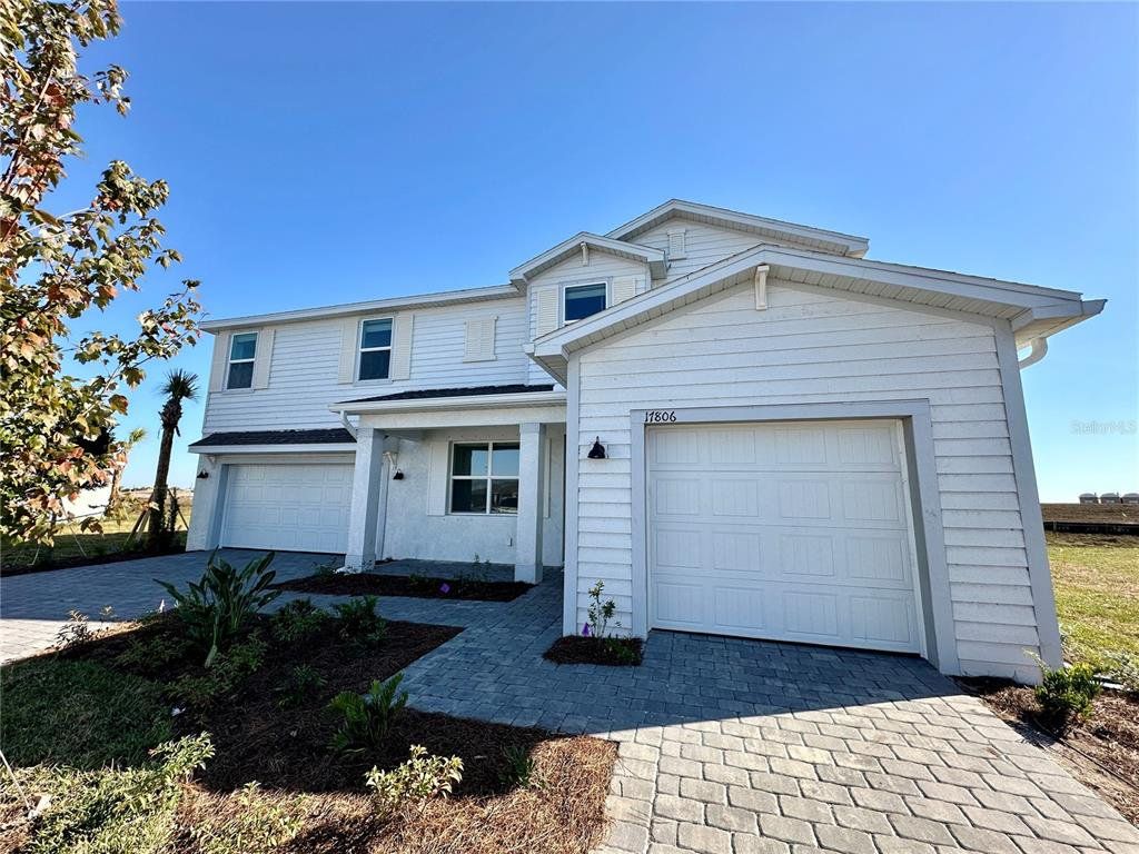 Front exterior of a new home in Rye Ranch, Parrish, FL, highlighting curb appeal (Image 1). Front exterior of a new home in Rye Ranch, Parrish, FL, highlighting curb appeal (Image 1).
