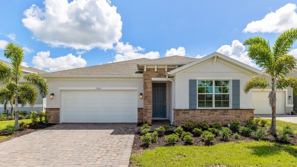 Front exterior of a new home in Coral Lakes - Tradition & Express, Punta Gorda, FL, highlighting curb appeal (Image 1). Front exterior of a new home in Coral Lakes - Tradition & Express, Punta Gorda, FL, highlighting curb appeal (Image 1).