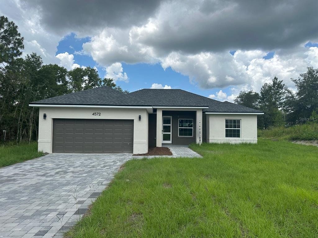 Front exterior of a new home in , Ocala, FL, highlighting curb appeal (Image 1).