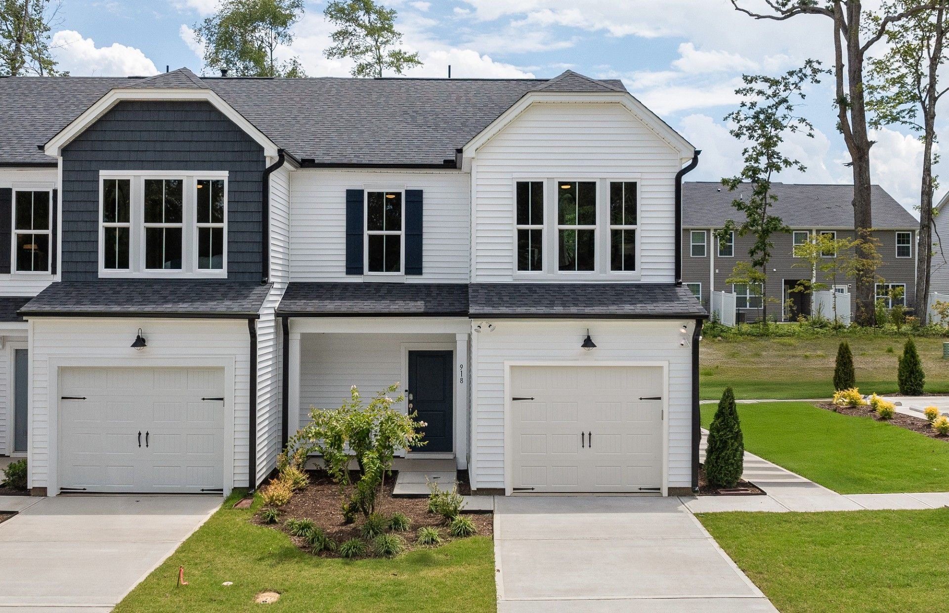 Front exterior of a new home in Poets Walk, Whitsett, NC, highlighting curb appeal (Image 1). Front exterior of a new home in Poets Walk, Whitsett, NC, highlighting curb appeal (Image 1).