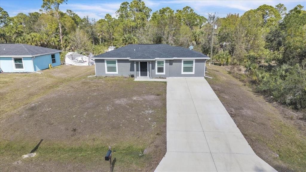 Front exterior of a new home in , Punta Gorda, FL, highlighting curb appeal (Image 1). Front exterior of a new home in , Punta Gorda, FL, highlighting curb appeal (Image 1).