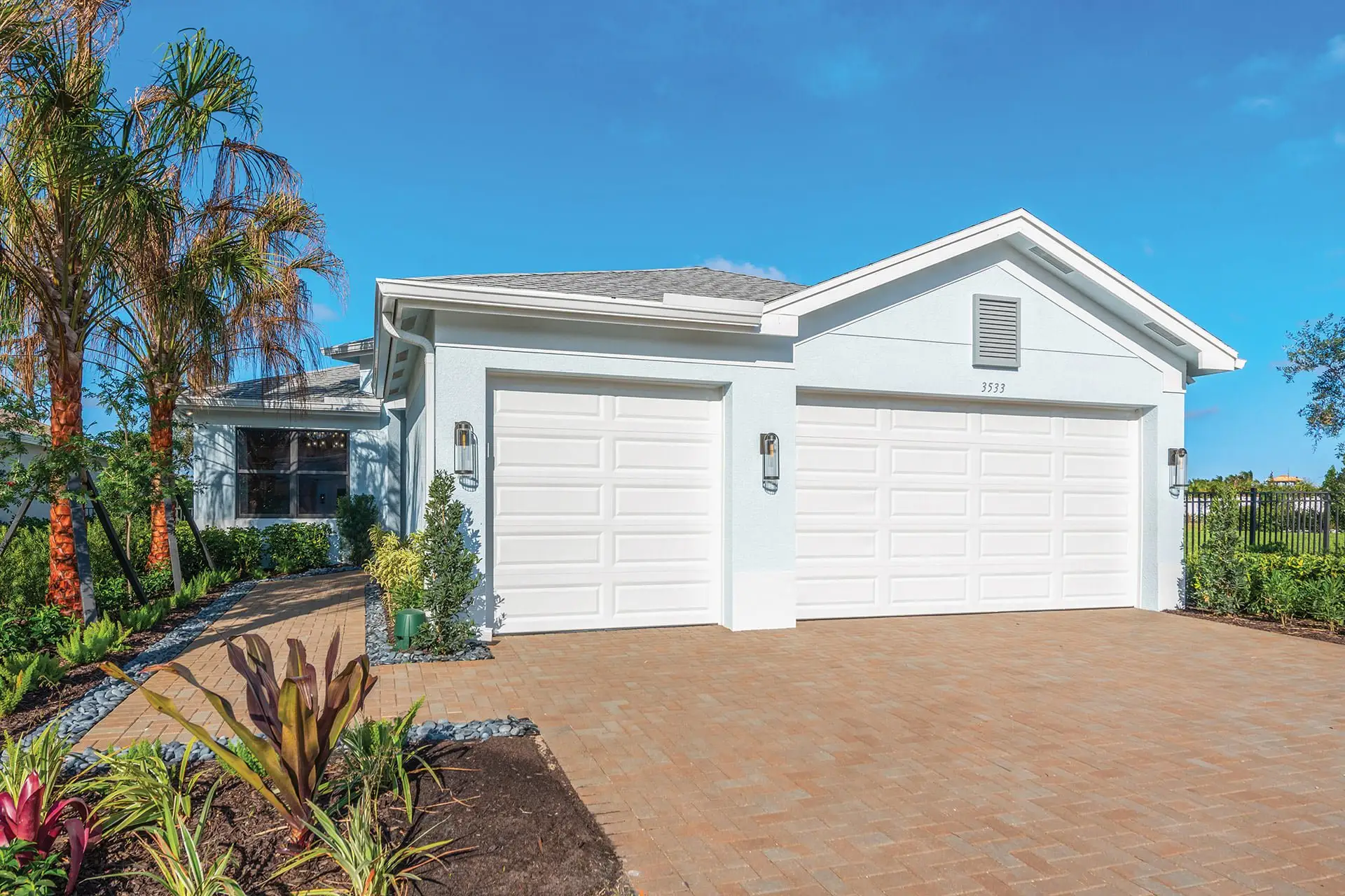 Front exterior of a new home in Valencia Harbor (55+), Fort Myers, FL, highlighting curb appeal (Image 1). Front exterior of a new home in Valencia Harbor (55+), Fort Myers, FL, highlighting curb appeal (Image 1).