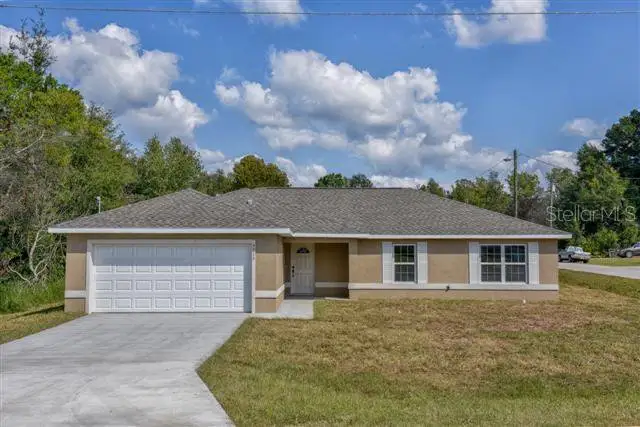 Front exterior of a new home in , Dunnellon, FL, highlighting curb appeal (Image 1).