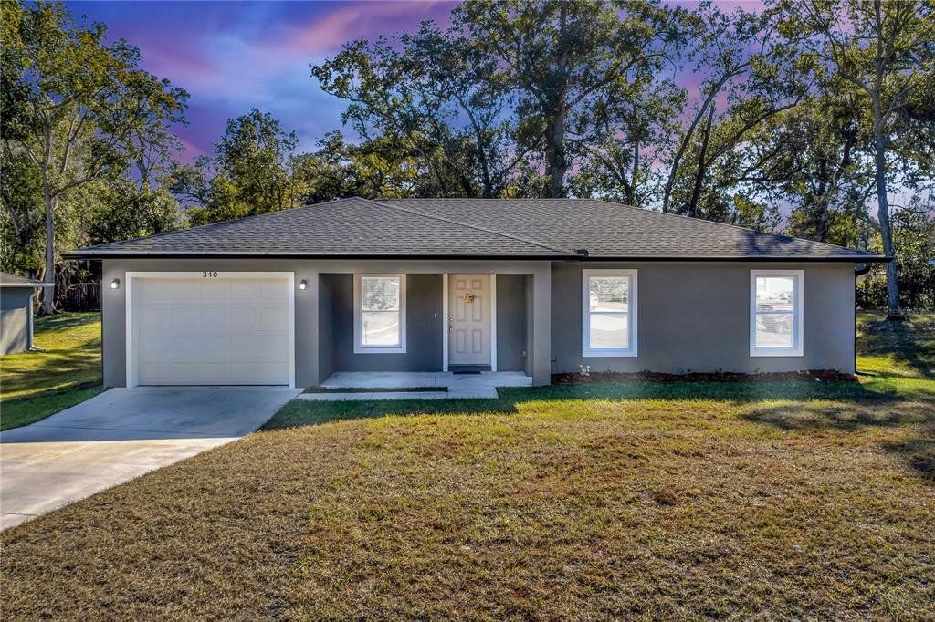 Front exterior of a new home in , Orange City, FL, highlighting curb appeal (Image 1). Front exterior of a new home in , Orange City, FL, highlighting curb appeal (Image 1).