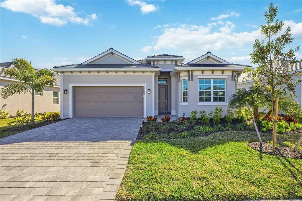 Front exterior of a new home in Wellen Park Golf & Country Club, Venice, FL, highlighting curb appeal (Image 1). Front exterior of a new home in Wellen Park Golf & Country Club, Venice, FL, highlighting curb appeal (Image 1).