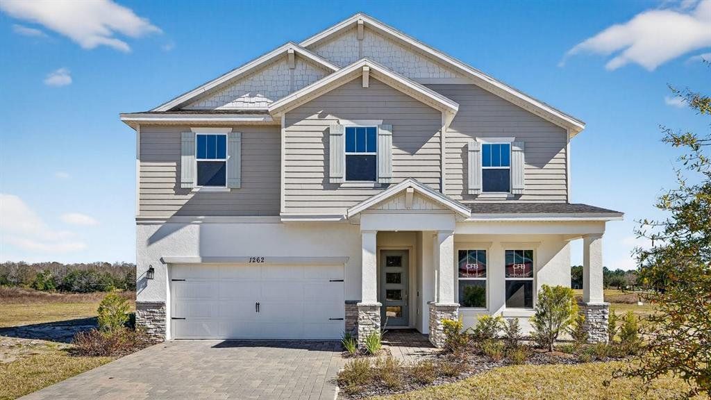 Front exterior of a new home in Gray Hawk at Hole Two, Daytona Beach, FL, highlighting curb appeal (Image 1). Front exterior of a new home in Gray Hawk at Hole Two, Daytona Beach, FL, highlighting curb appeal (Image 1).