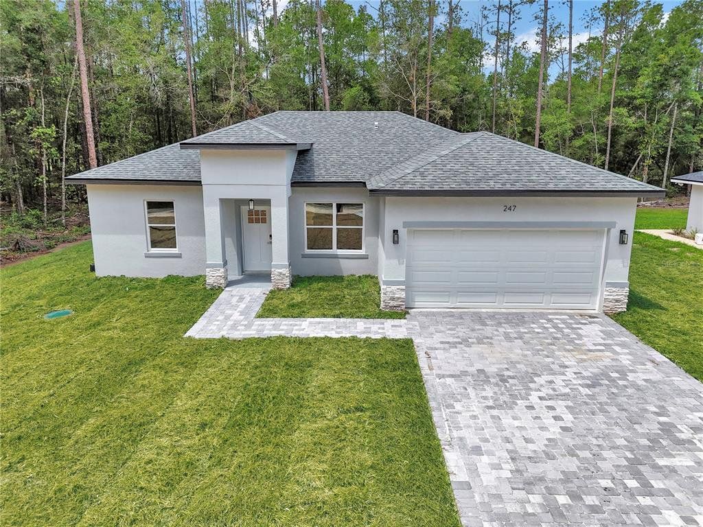 Front exterior of a new home in , Citrus Springs, FL, highlighting curb appeal (Image 1). Front exterior of a new home in , Citrus Springs, FL, highlighting curb appeal (Image 1).