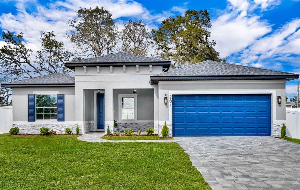 Front exterior of a new home in , Poinciana, FL, highlighting curb appeal (Image 1). Front exterior of a new home in , Poinciana, FL, highlighting curb appeal (Image 1).