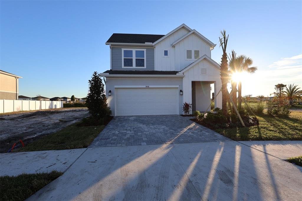 Front exterior of a new home in Chapel Crossings - Garden Series, Wesley Chapel, FL, highlighting curb appeal (Image 1). Front exterior of a new home in Chapel Crossings - Garden Series, Wesley Chapel, FL, highlighting curb appeal (Image 1).
