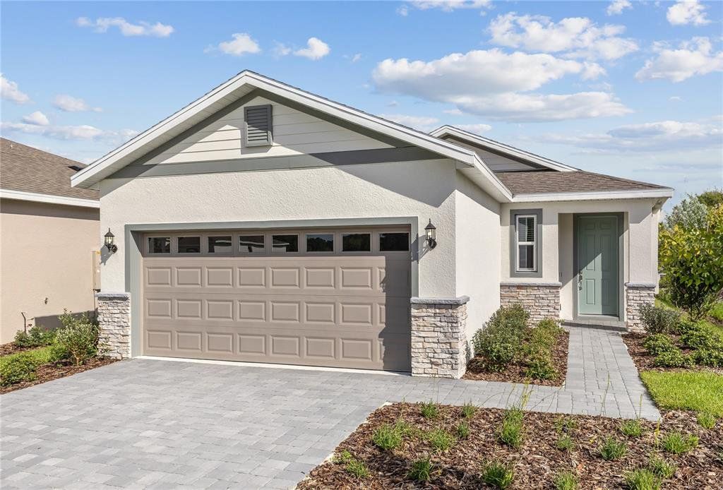 Front exterior of a new home in Highfield at Twisted Oaks, Wildwood, FL, highlighting curb appeal (Image 1). Front exterior of a new home in Highfield at Twisted Oaks, Wildwood, FL, highlighting curb appeal (Image 1).