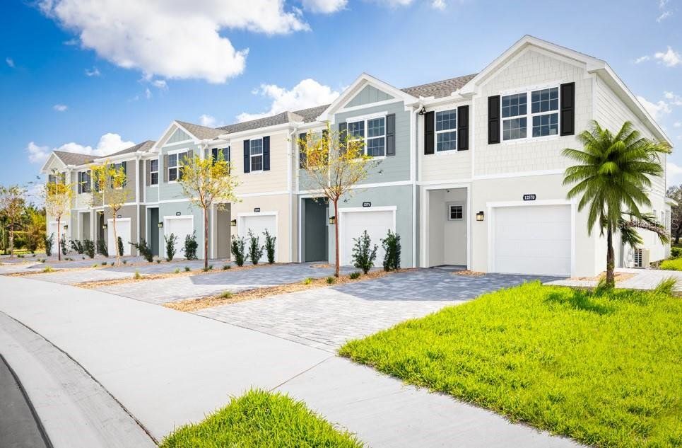 Front exterior of a new home in , Davenport, FL, highlighting curb appeal (Image 1).