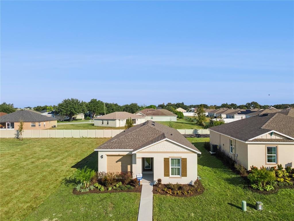Front exterior of a new home in Leoma's Landing, Lake Wales, FL, highlighting curb appeal (Image 1). Front exterior of a new home in Leoma's Landing, Lake Wales, FL, highlighting curb appeal (Image 1).