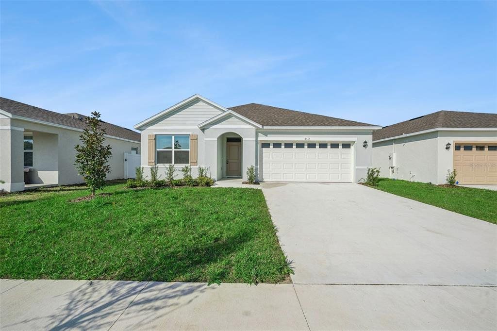 Front exterior of a new home in , Tavares, FL, highlighting curb appeal (Image 1). Front exterior of a new home in , Tavares, FL, highlighting curb appeal (Image 1).