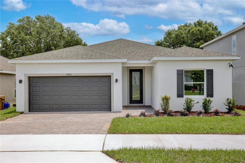 Front exterior of a new home in , Groveland, FL, highlighting curb appeal (Image 1). Front exterior of a new home in , Groveland, FL, highlighting curb appeal (Image 1).
