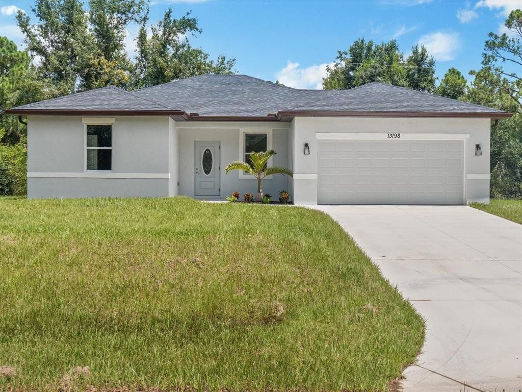 Front exterior of a new home in , North Port, FL, highlighting curb appeal (Image 1). Front exterior of a new home in , North Port, FL, highlighting curb appeal (Image 1).