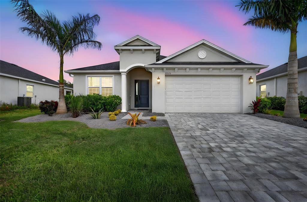 Front exterior of a new home in , Parrish, FL, highlighting curb appeal (Image 1).