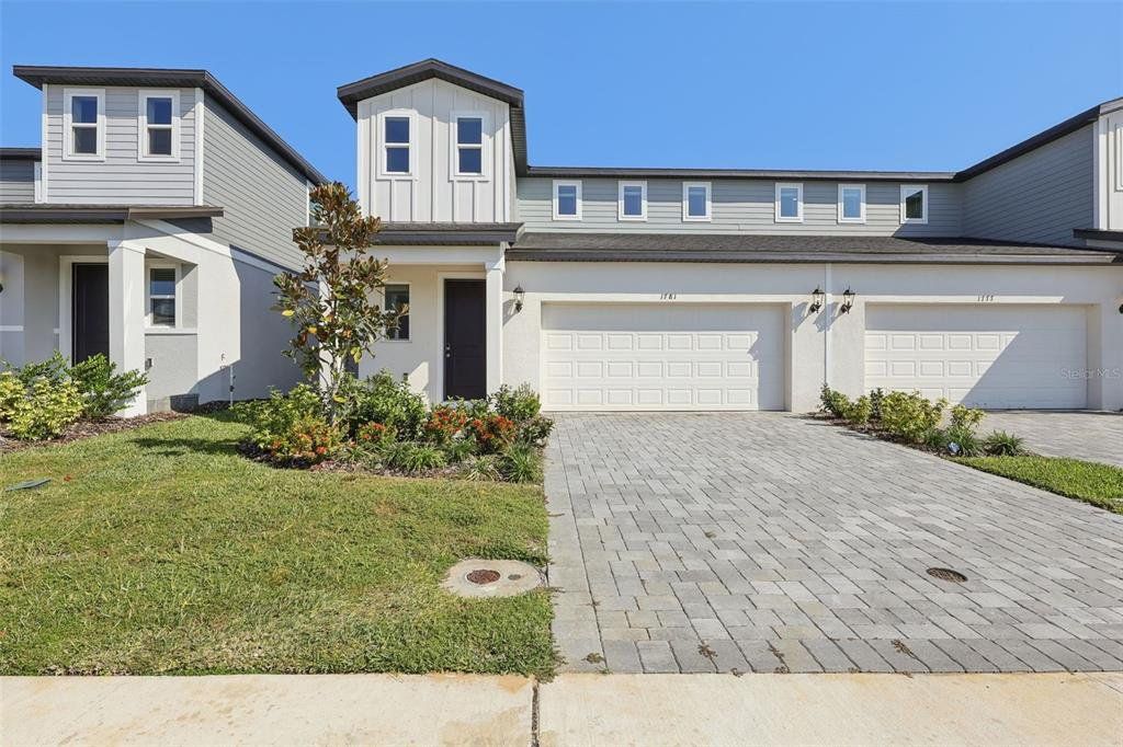 Front exterior of a new home in Cyrene at Minneola, Clermont, FL, highlighting curb appeal (Image 1). Front exterior of a new home in Cyrene at Minneola, Clermont, FL, highlighting curb appeal (Image 1).