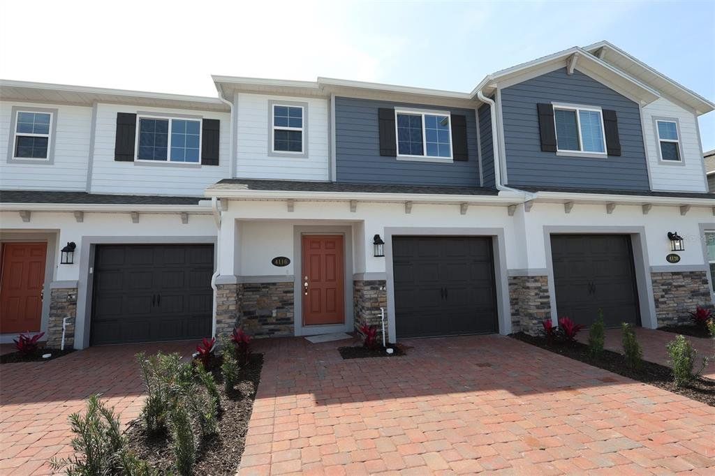 Front exterior of a new home in Tyson Ranch, Orlando, FL, highlighting curb appeal (Image 1). Front exterior of a new home in Tyson Ranch, Orlando, FL, highlighting curb appeal (Image 1).