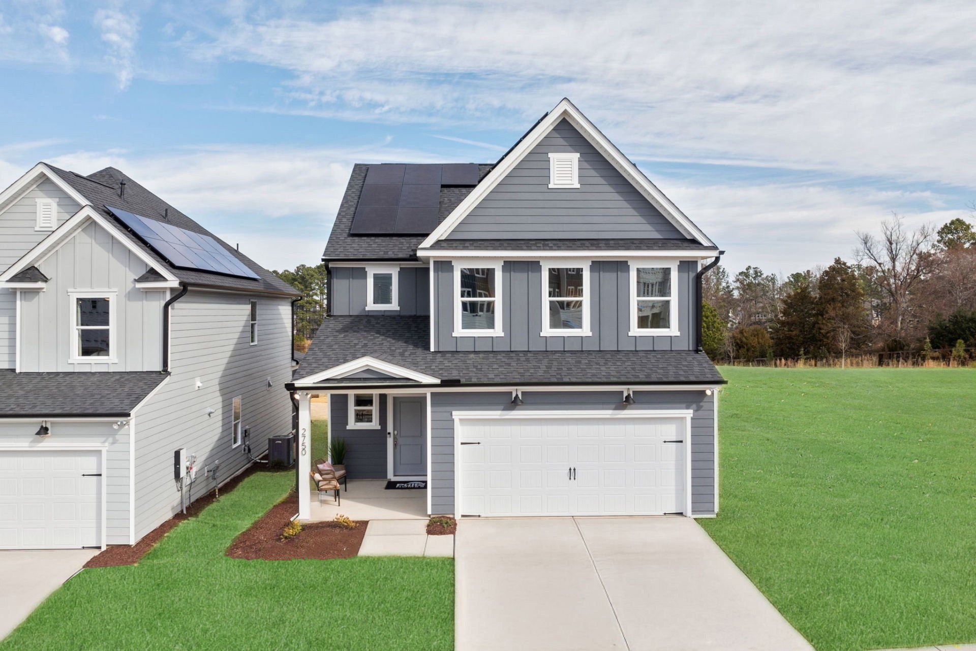 Front exterior of a new home in Exchange at 401, Raleigh, NC, highlighting curb appeal (Image 1). Front exterior of a new home in Exchange at 401, Raleigh, NC, highlighting curb appeal (Image 1).