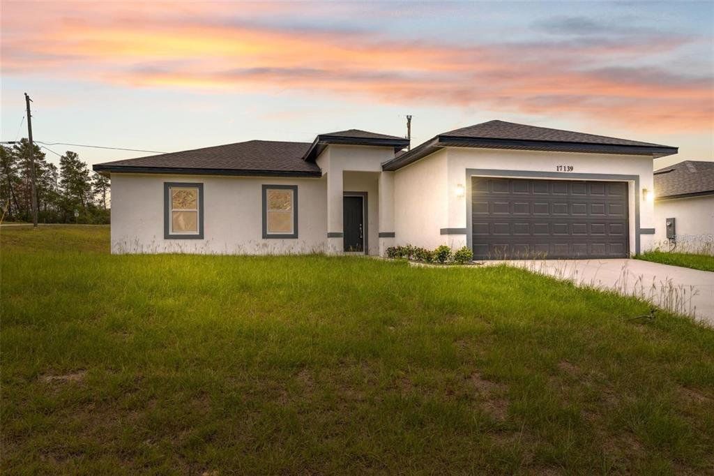 Front exterior of a new home in , Ocala, FL, highlighting curb appeal (Image 1). Front exterior of a new home in , Ocala, FL, highlighting curb appeal (Image 1).