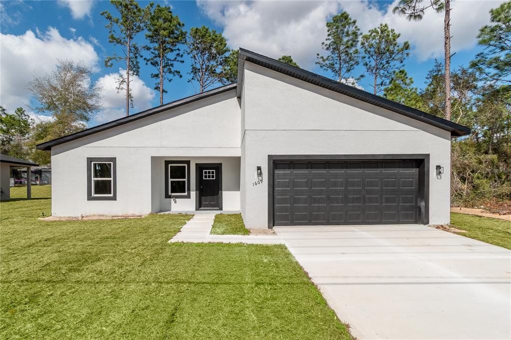 Front exterior of a new home in , Citrus Springs, FL, highlighting curb appeal (Image 1). Front exterior of a new home in , Citrus Springs, FL, highlighting curb appeal (Image 1).