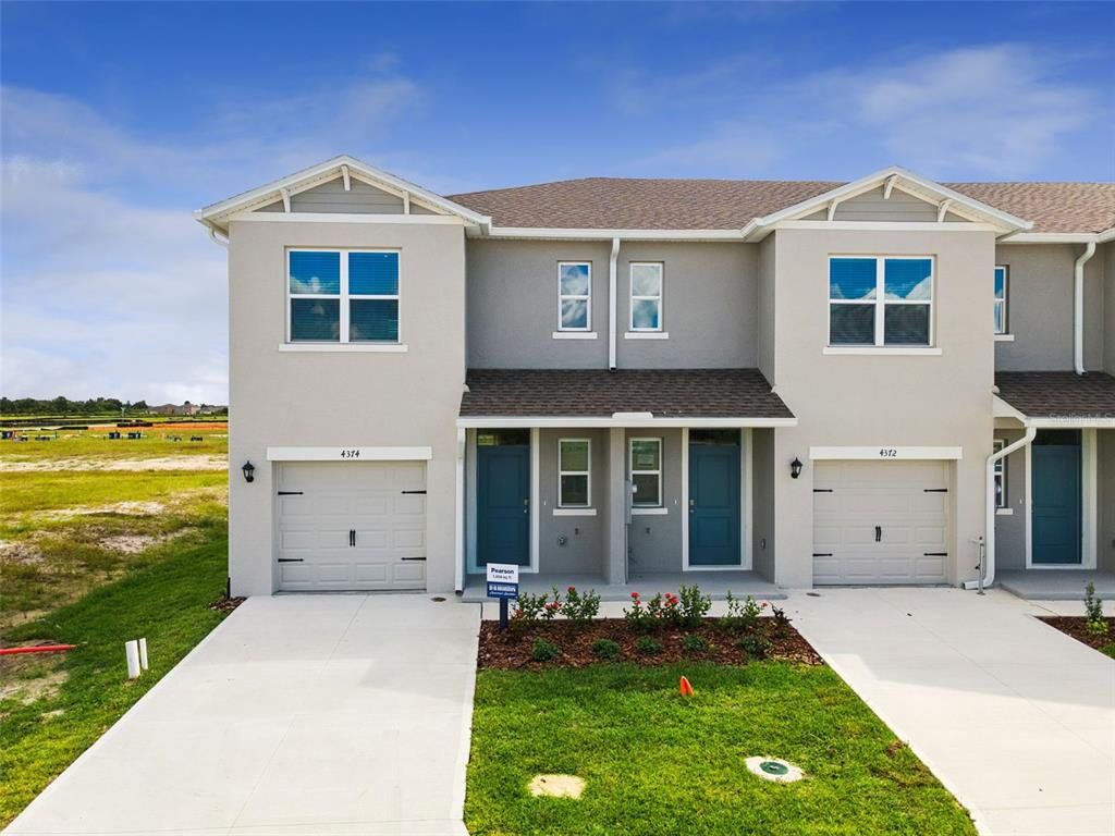 Front exterior of a new home in Summerlin at Hawthorne Ranch, Lakeland, FL, highlighting curb appeal (Image 1). Front exterior of a new home in Summerlin at Hawthorne Ranch, Lakeland, FL, highlighting curb appeal (Image 1).