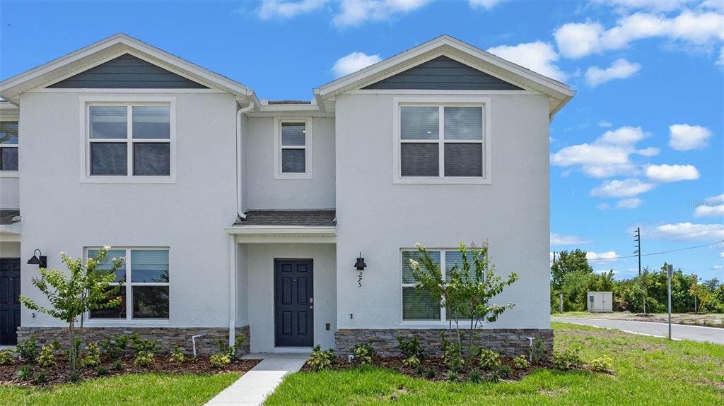 Front exterior of a new home in Preston Cove, St. Cloud, FL, highlighting curb appeal (Image 1). Front exterior of a new home in Preston Cove, St. Cloud, FL, highlighting curb appeal (Image 1).