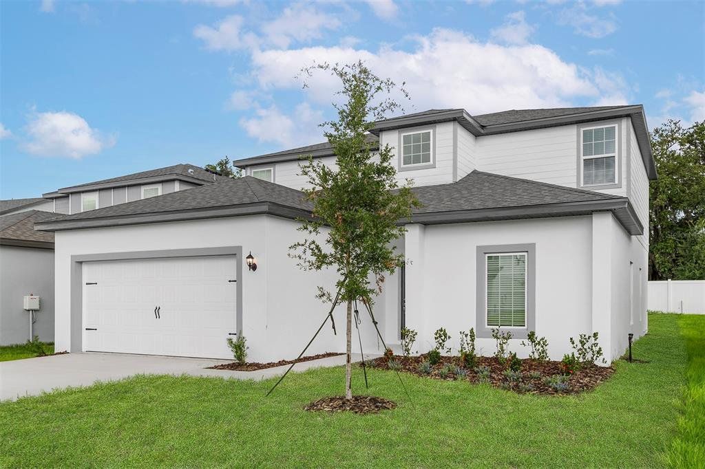 Front exterior of a new home in Tula Parc, Astatula, FL, highlighting curb appeal (Image 1). Front exterior of a new home in Tula Parc, Astatula, FL, highlighting curb appeal (Image 1).
