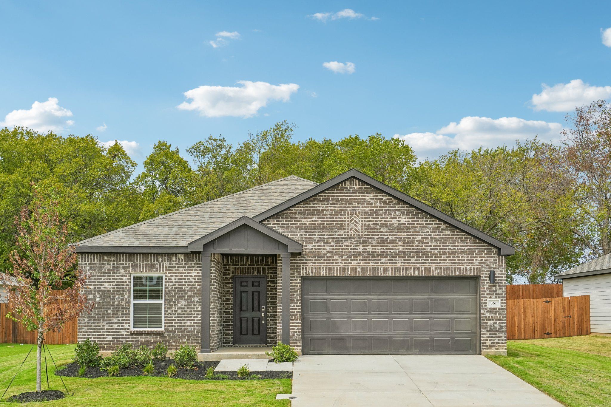 Front exterior of a new home in Pennsylvania Avenue, Springtown, TX, highlighting curb appeal (Image 1). Front exterior of a new home in Pennsylvania Avenue, Springtown, TX, highlighting curb appeal (Image 1).