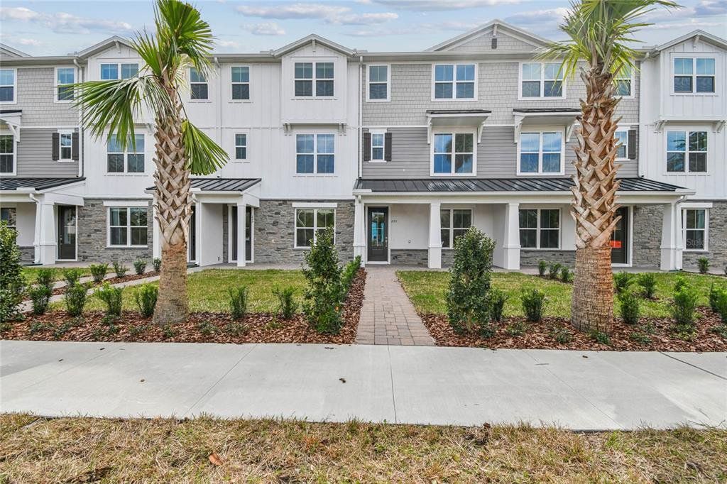 Front exterior of a new home in Townes at Northlake, Oviedo, FL, highlighting curb appeal (Image 1). Front exterior of a new home in Townes at Northlake, Oviedo, FL, highlighting curb appeal (Image 1).